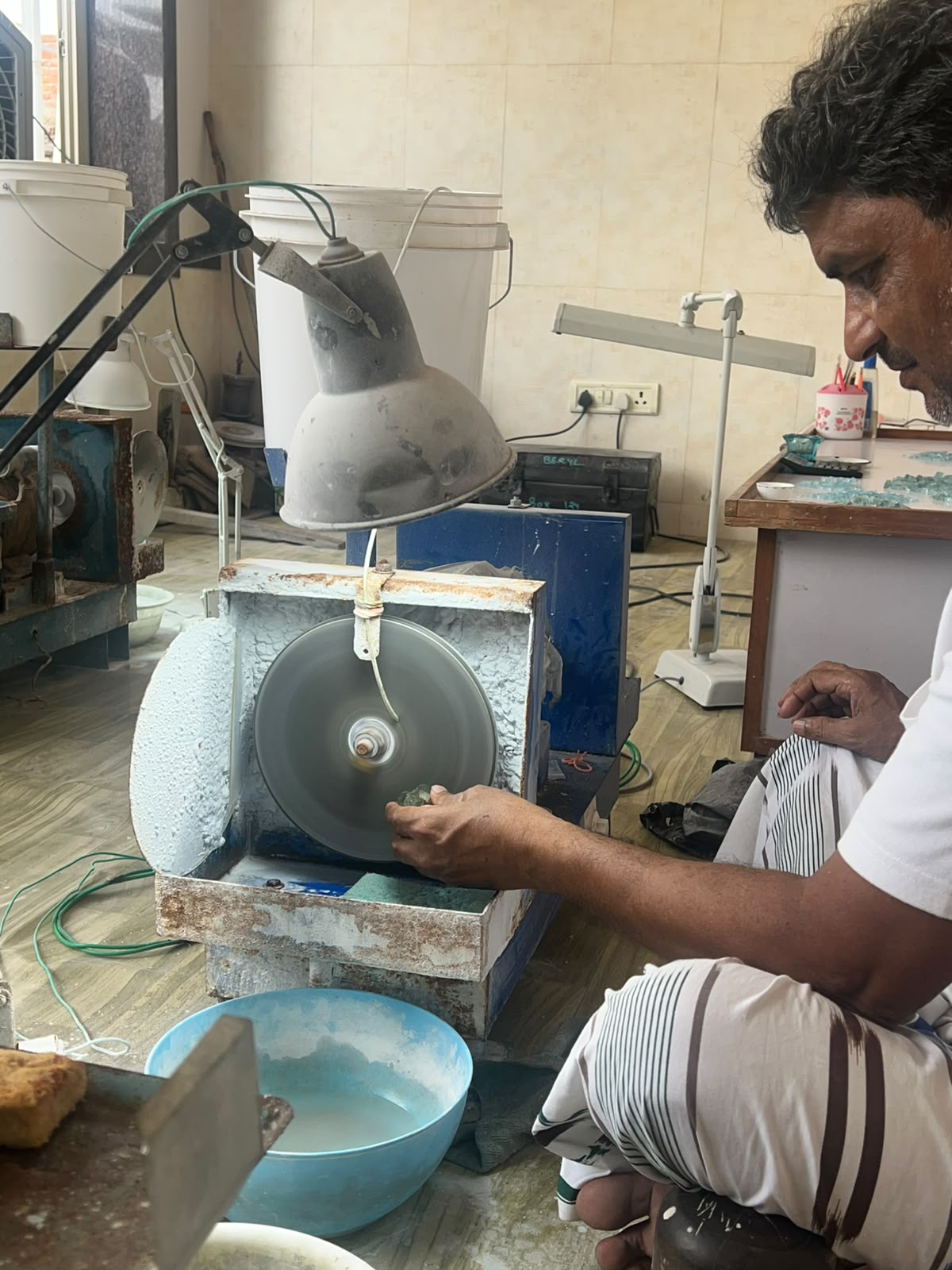 Faceting wheel in motion with sorted parcel in the background